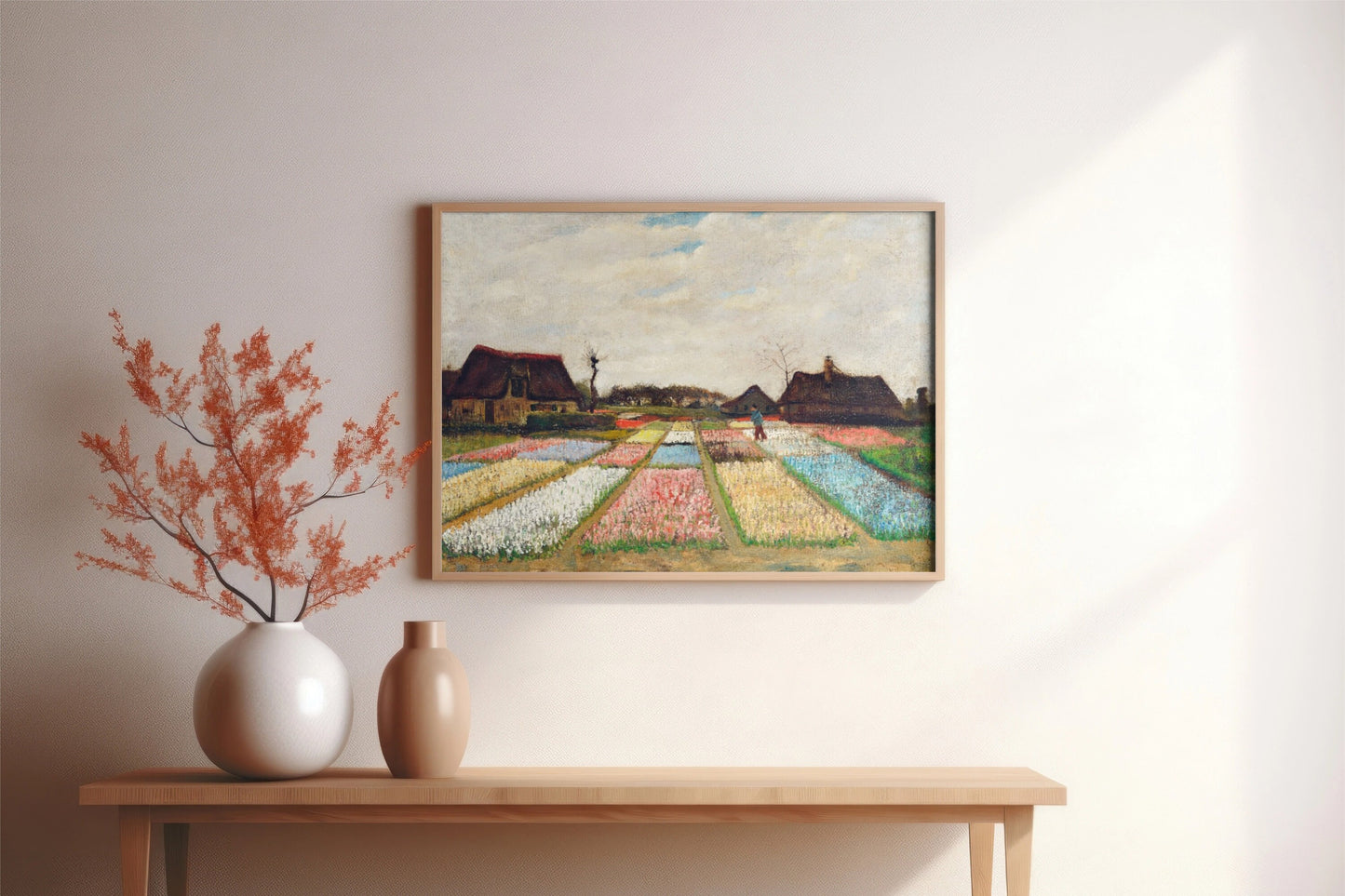 a painting on a wall above a table with vases