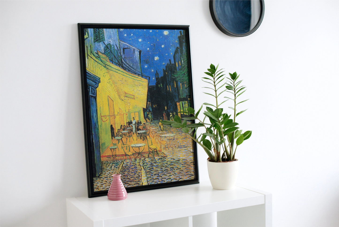a painting on a wall next to a potted plant