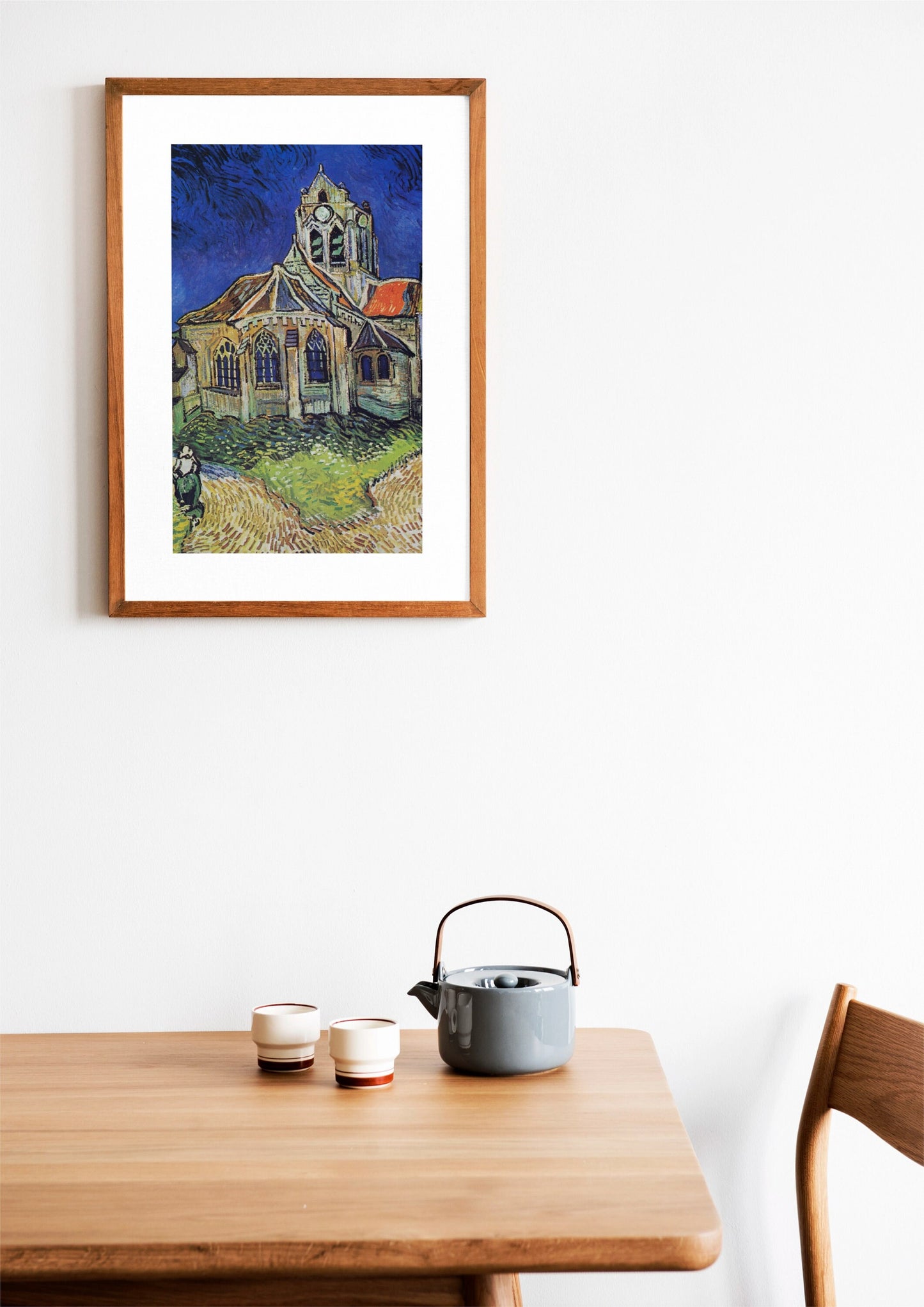 a painting of a house on a wall above a table