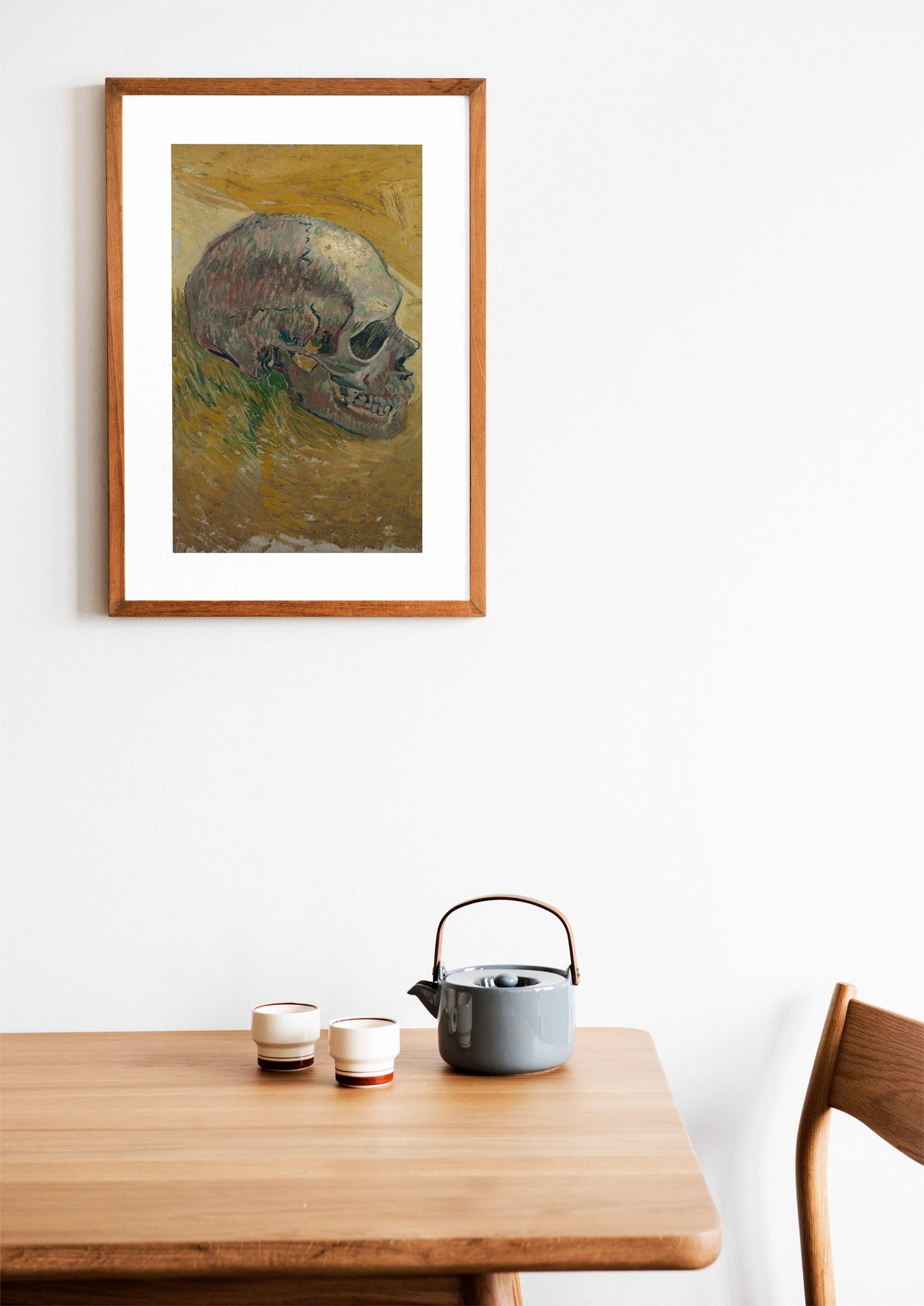 a painting of a skull on a wall above a table
