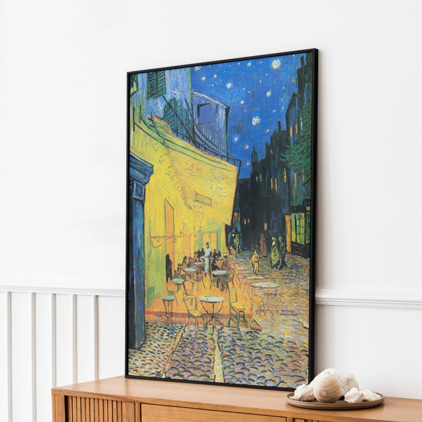 a painting of a cafe at night on a wall