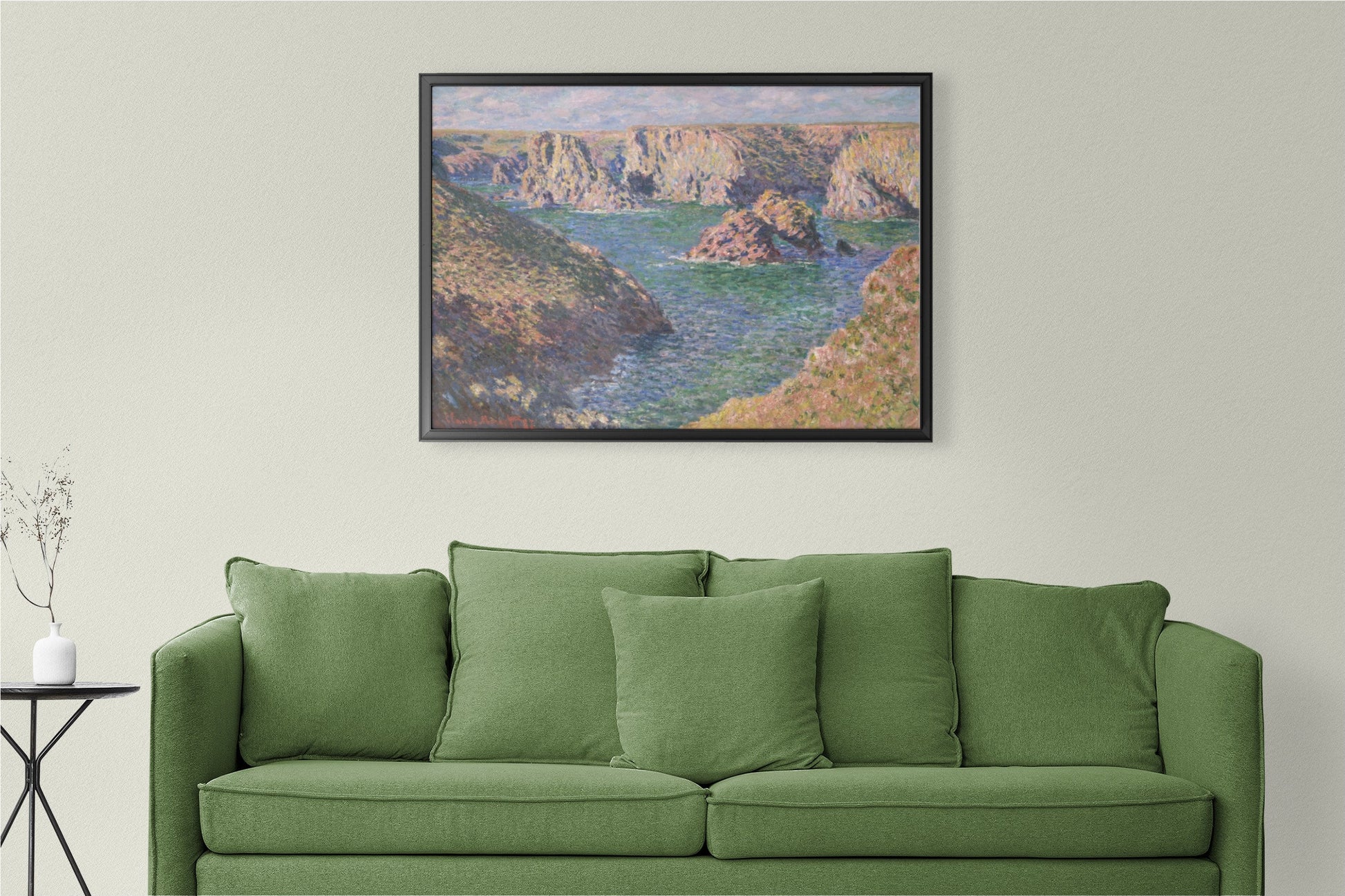 a living room with a green couch and a painting on the wall
