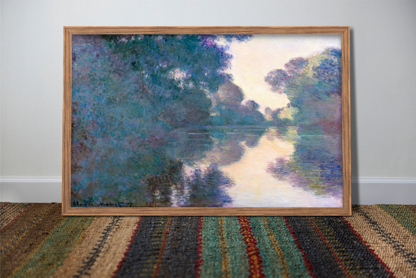 a painting of a river in a wooden frame