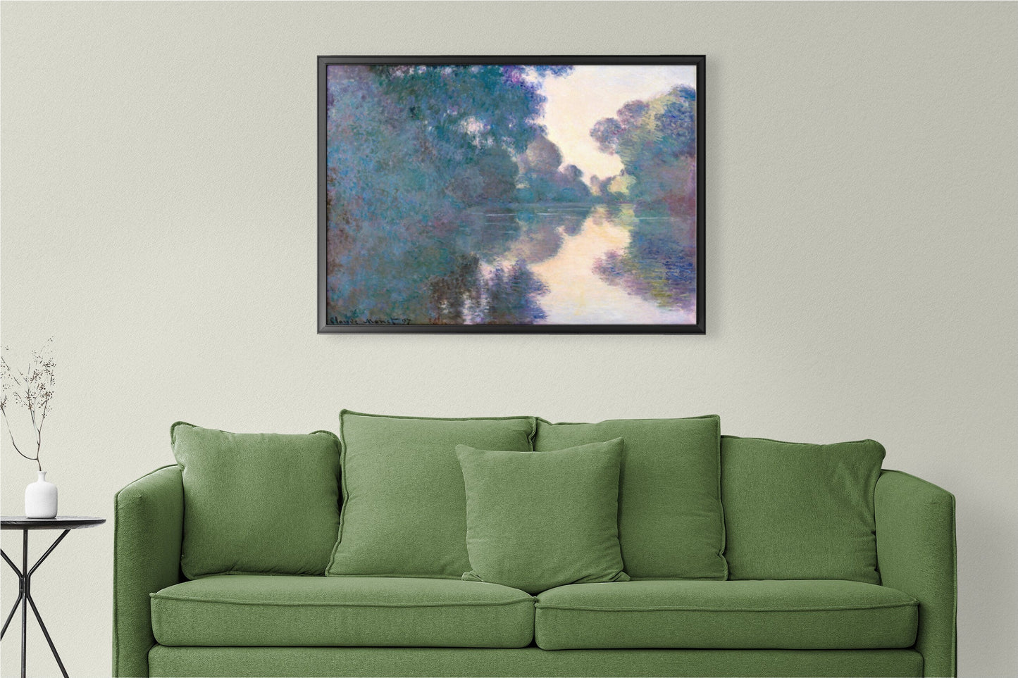 a living room with a green couch and a painting on the wall