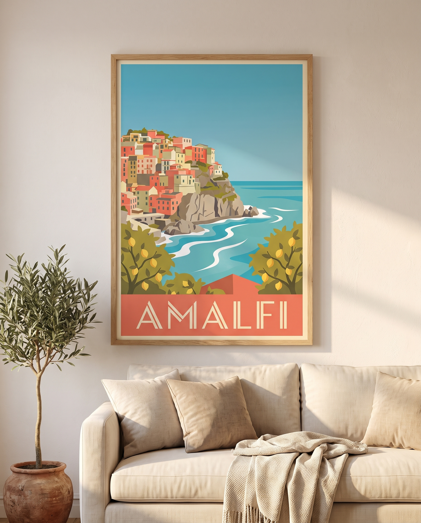 Amalfi travel poster framed in oak above a cream linen sofa