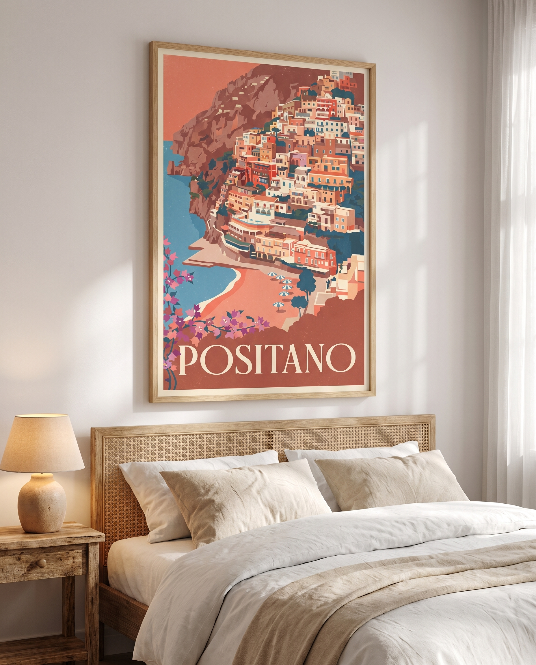 Positano travel poster framed in oak above a bed with rattan headboard