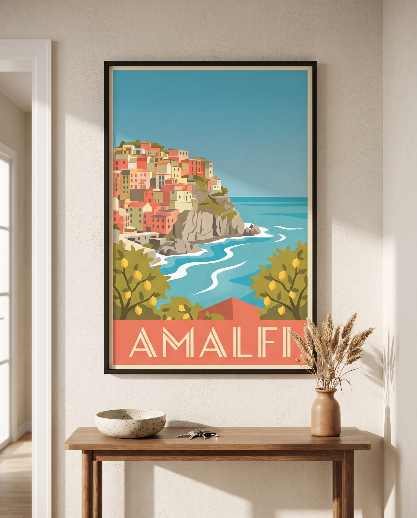 Amalfi travel poster framed in black above a hallway console table