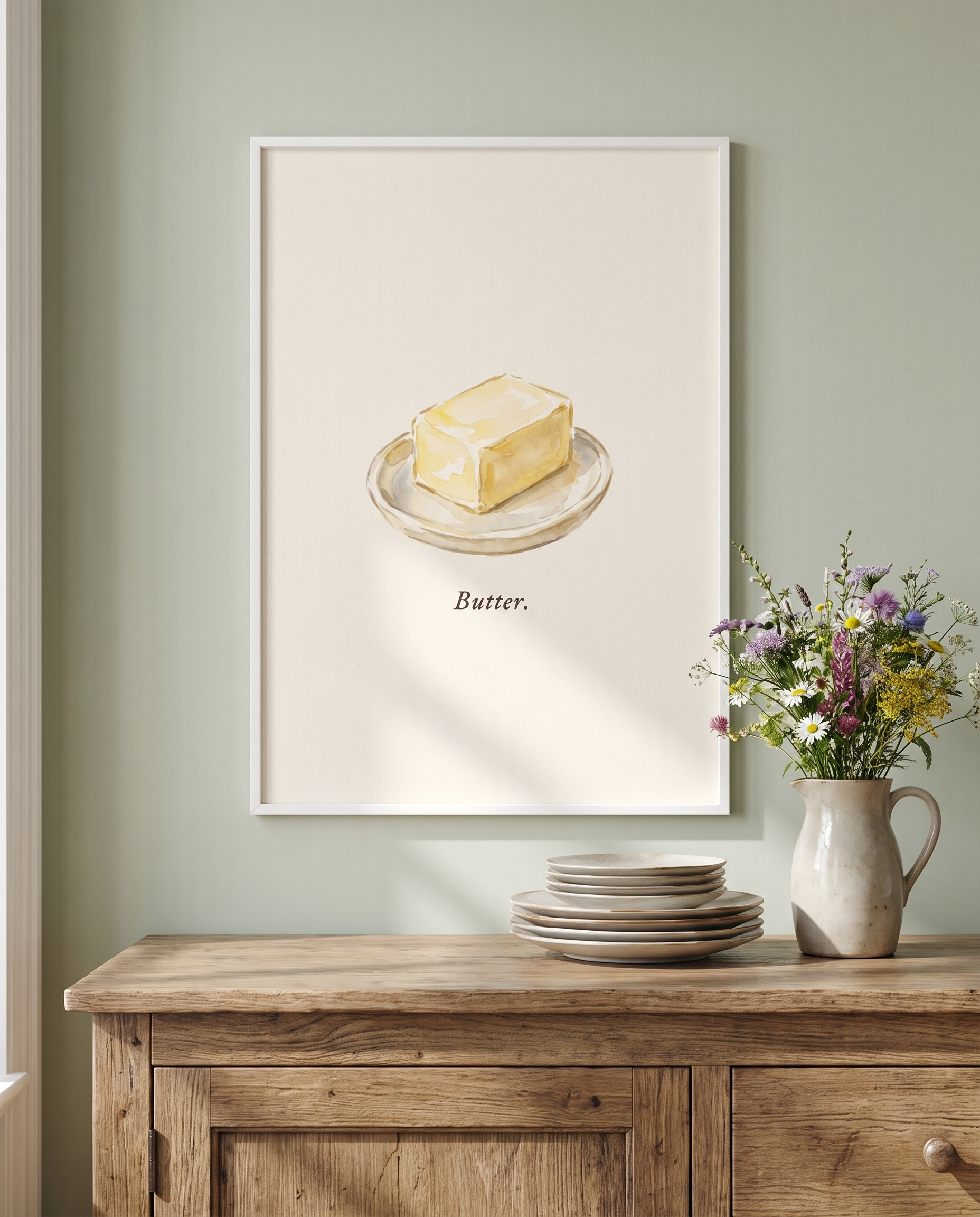 Butter kitchen print framed in white in a sage dining room