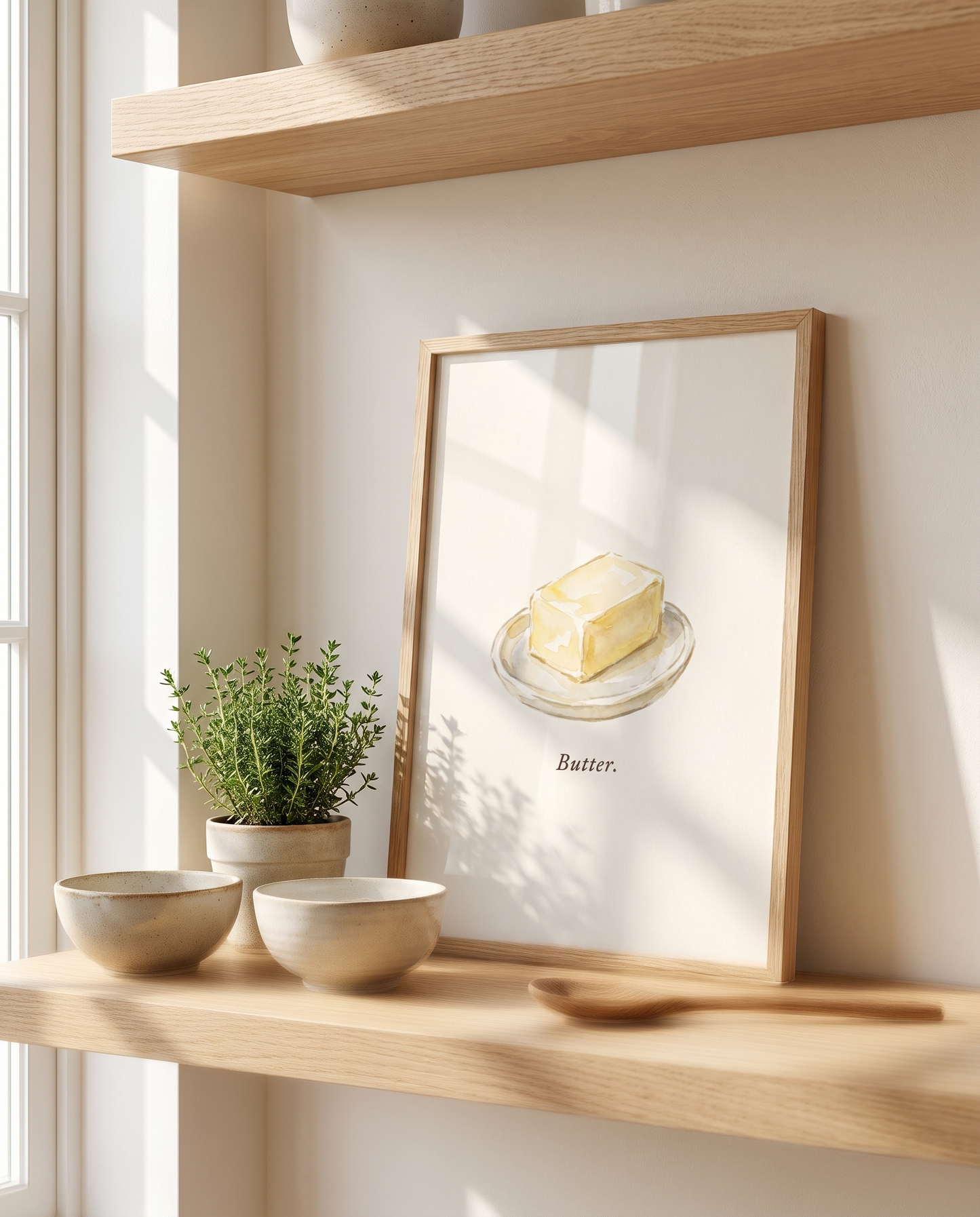 Butter kitchen print leaning on an oak kitchen shelf