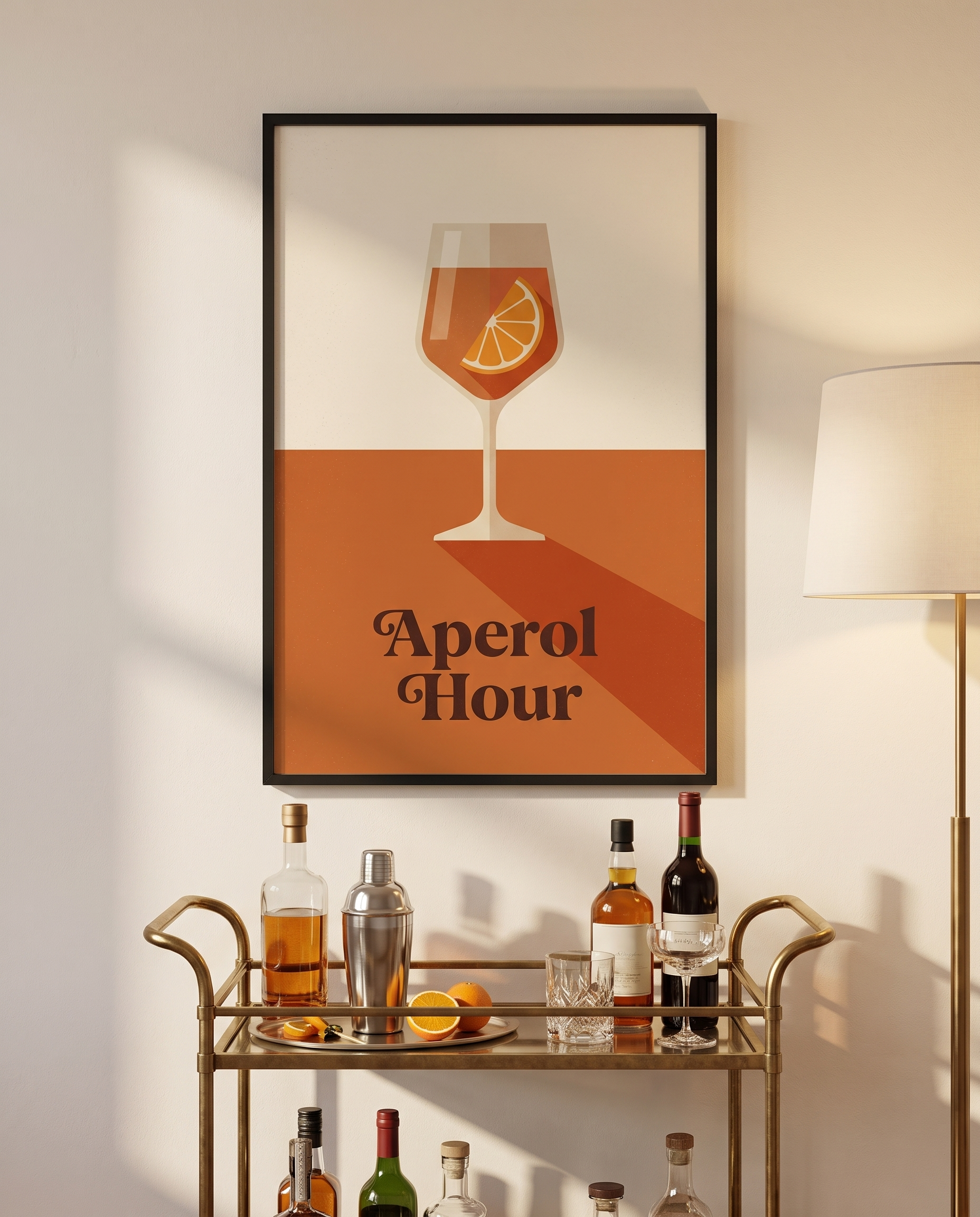 Aperol Hour print framed in black above a brass bar cart