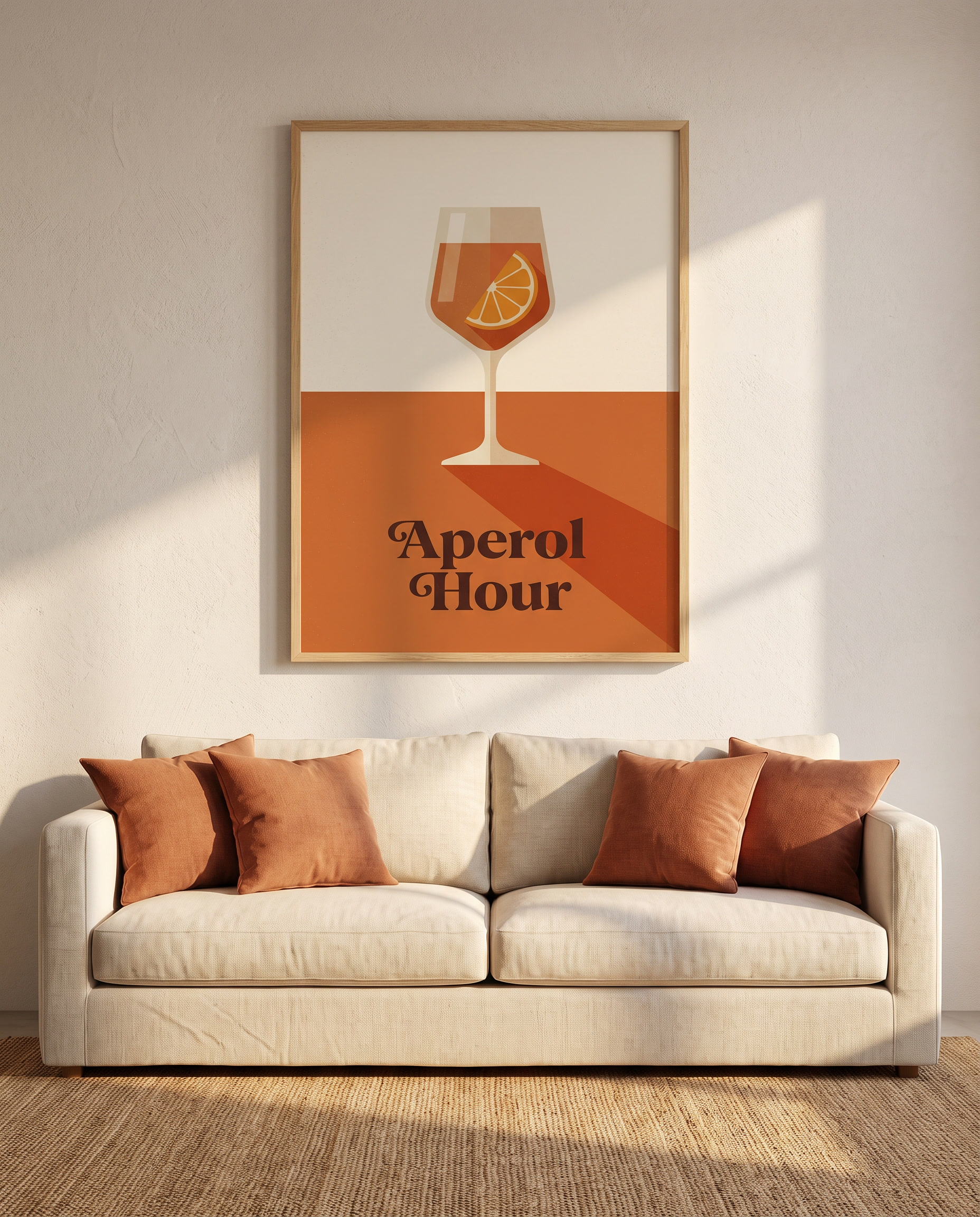 Aperol Hour print framed in oak above a linen sofa with terracotta cushions