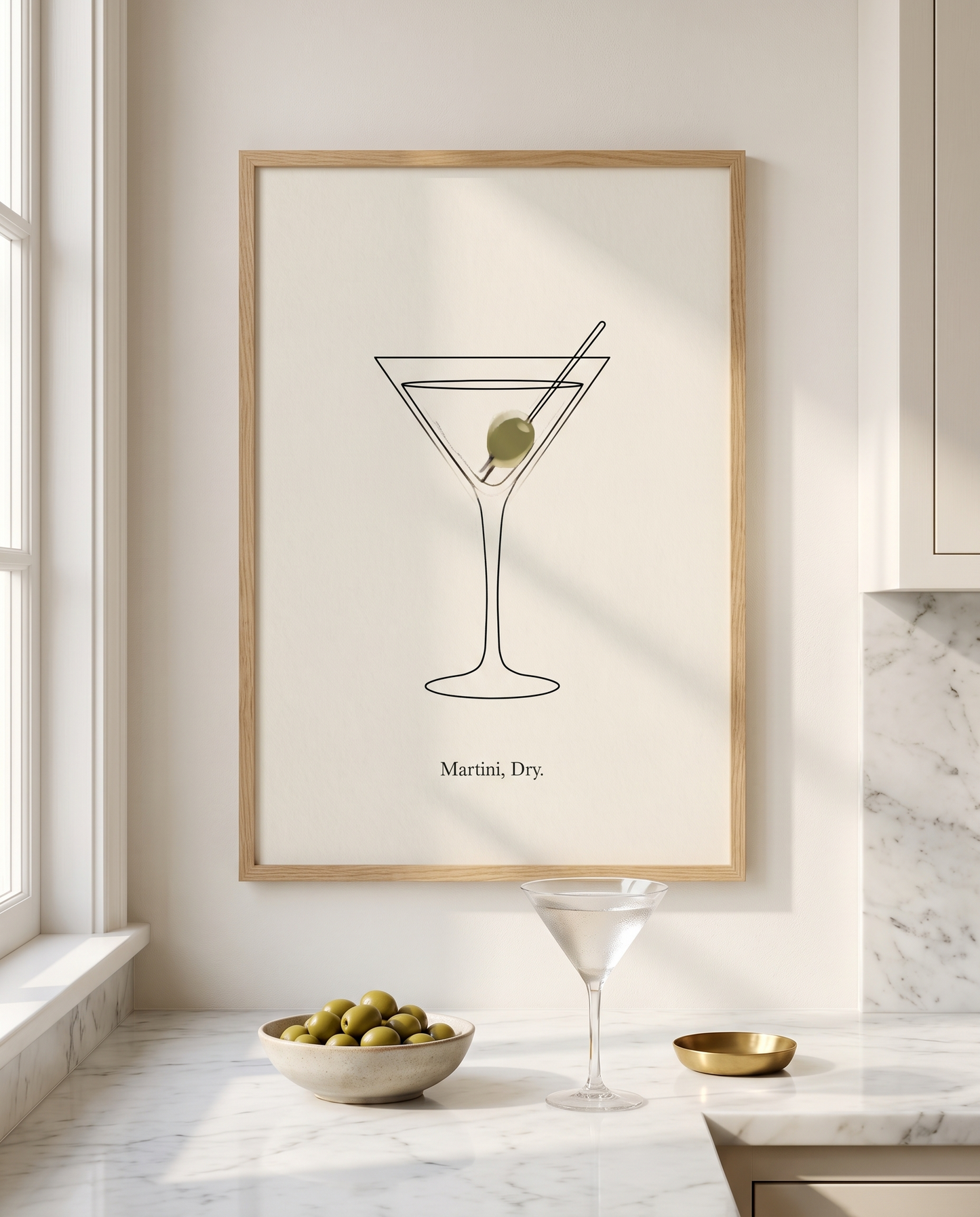 Martini Dry print framed in oak above a marble kitchen worktop