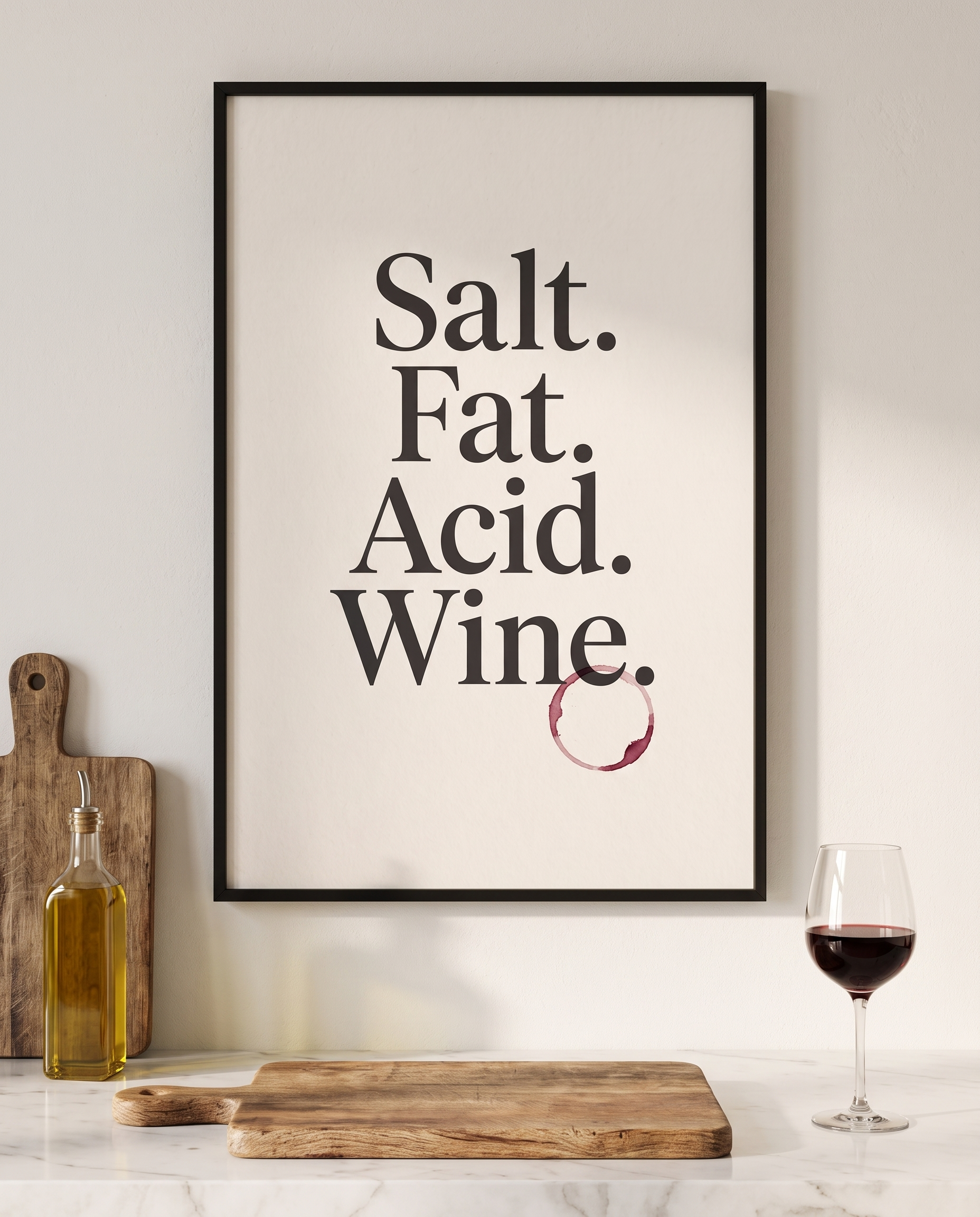 Salt Fat Acid Wine print framed in black above a marble kitchen worktop