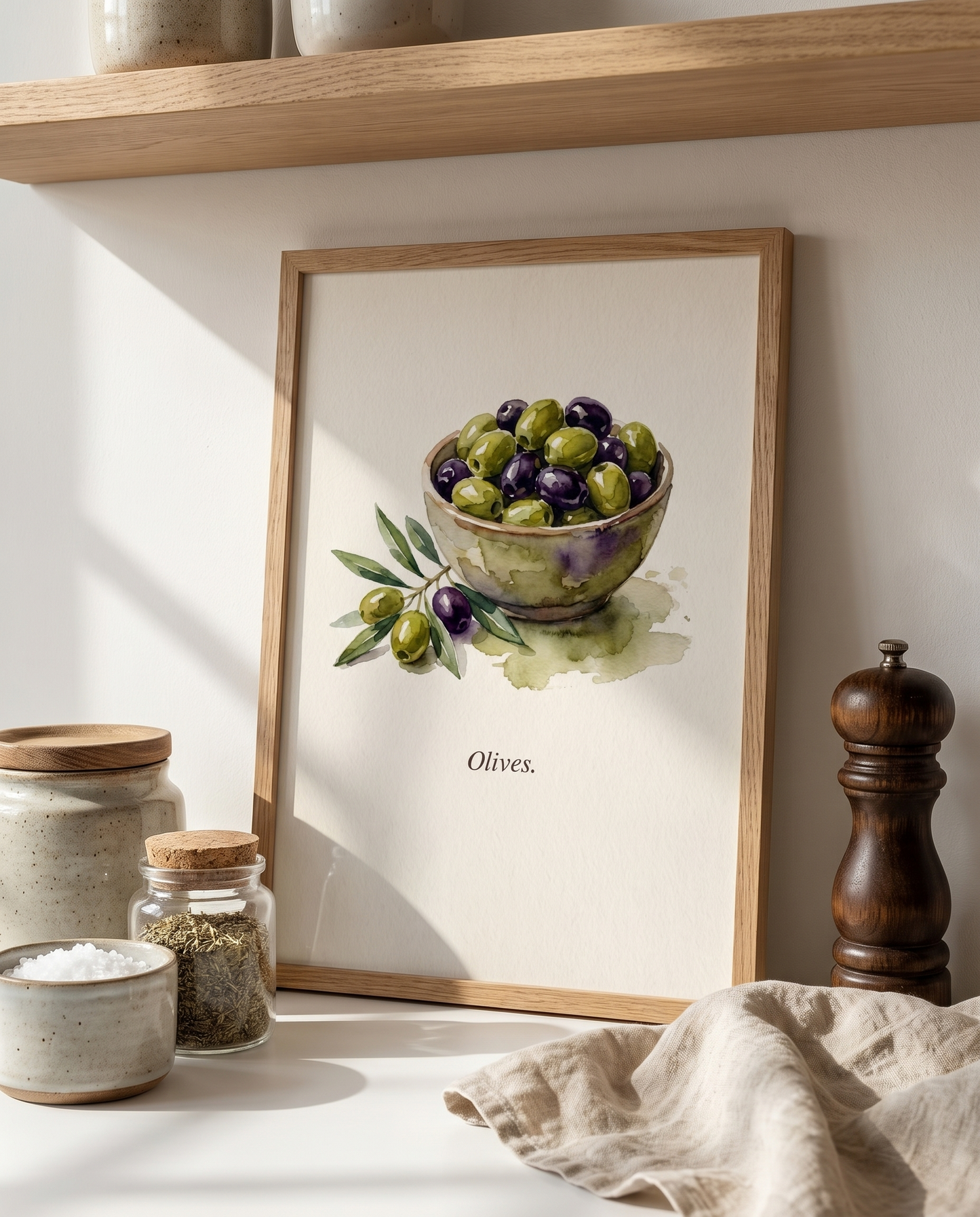 Olives kitchen print leaning on an oak kitchen shelf