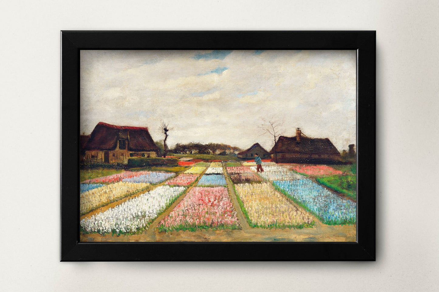 a painting on a wall of a field with houses in the background