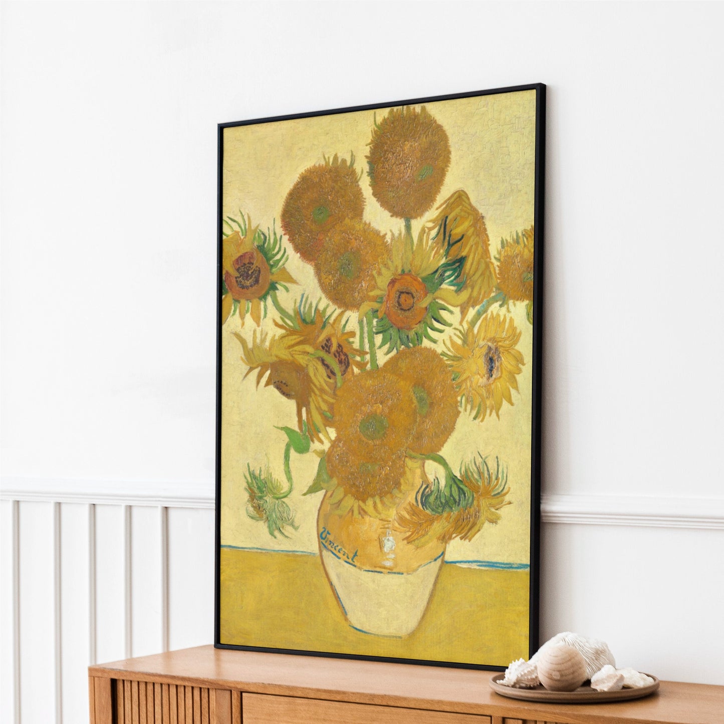 a painting of sunflowers in a vase on a dresser
